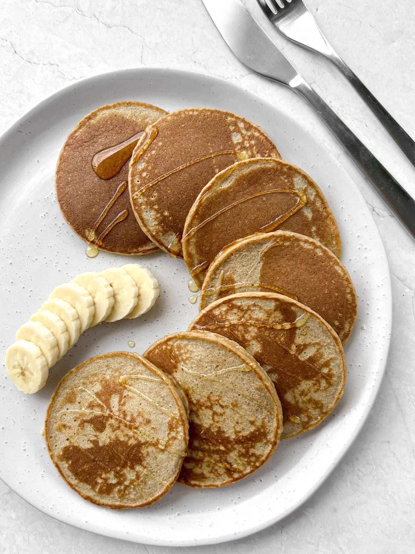 Banana oat pancakes on a serving plate