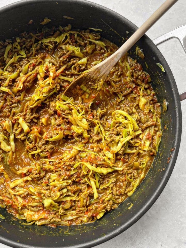 Sautéd beef mince, cabbage, tomatoes and stock in a large, deep, fry-pan. 