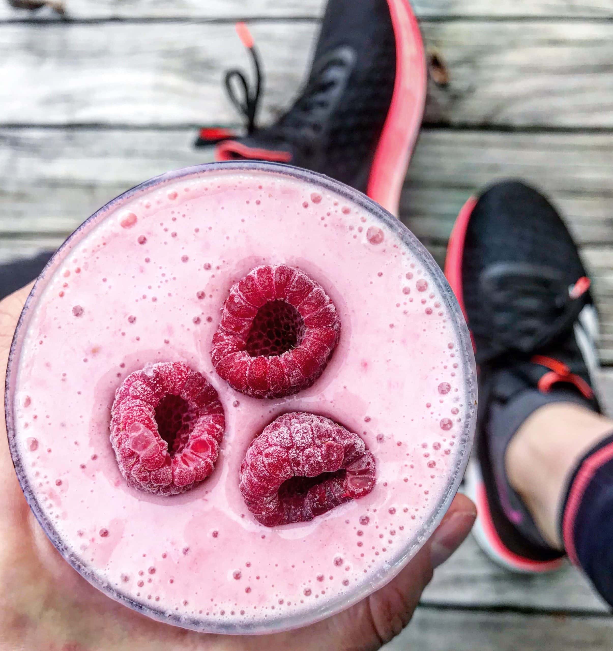 Berry Greek yoghurt smoothie in a glass topped with berries. 