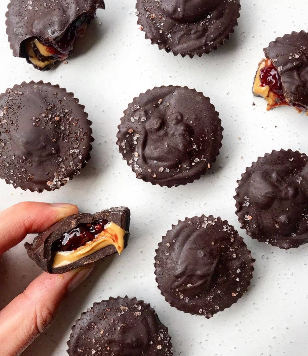 Peanut butter raspberry jelly cups on a white plate. 