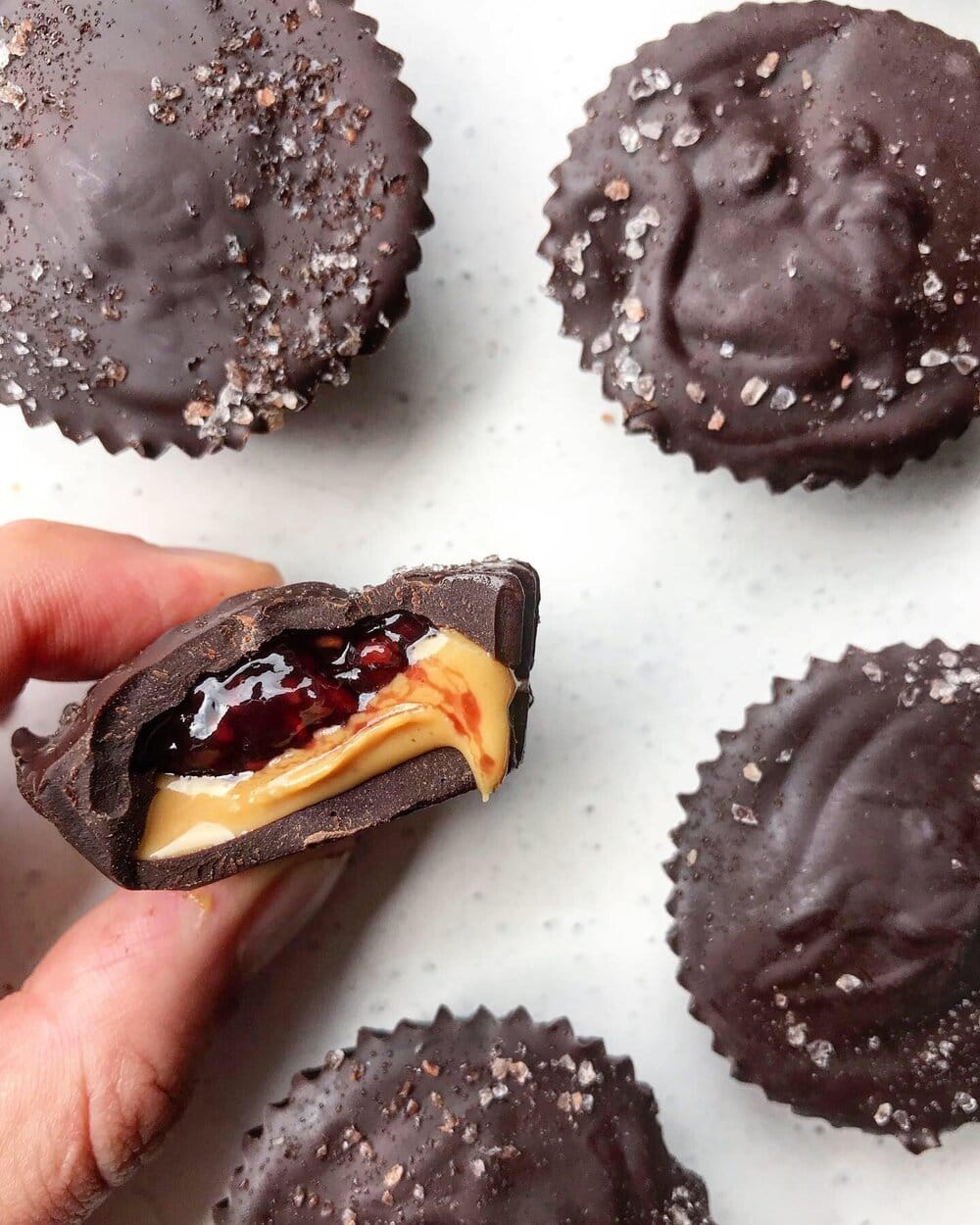 Peanut butter jelly cups on a white plate.