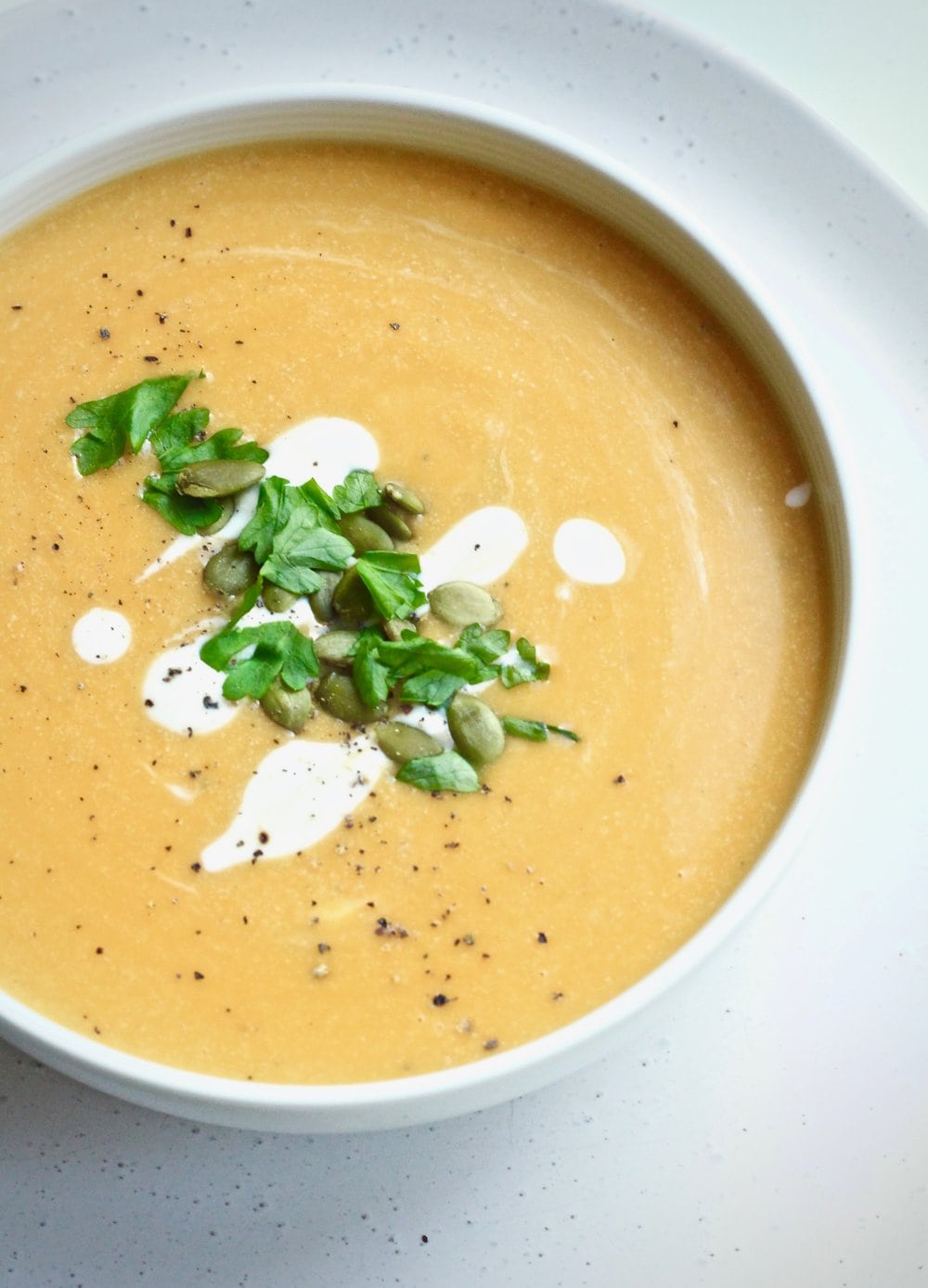 Close up of plant-based pumpkin soup with cashew cream. 