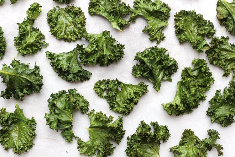 Tray of crispy green kale chips fresh out of the oven. 