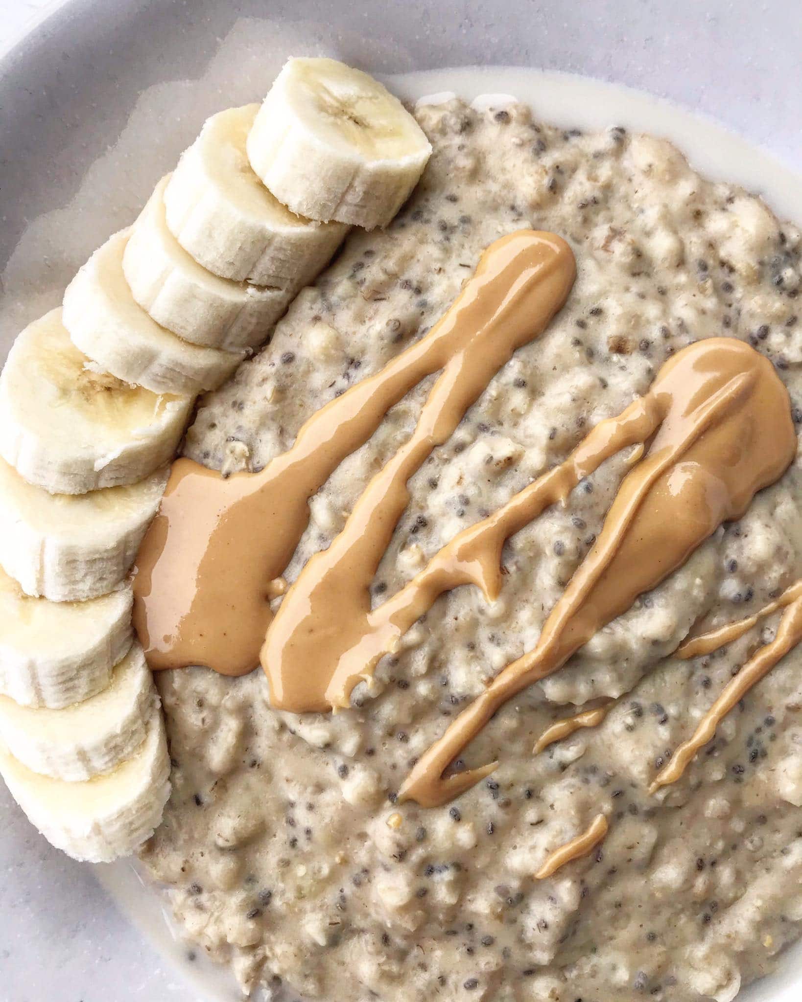 A close up of banana chia porridge with sliced banana on top.