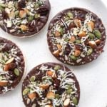 Rice cakes topped with chocolate and sprinkled with a mixture of nuts, seeds, dried fruit and coconut.