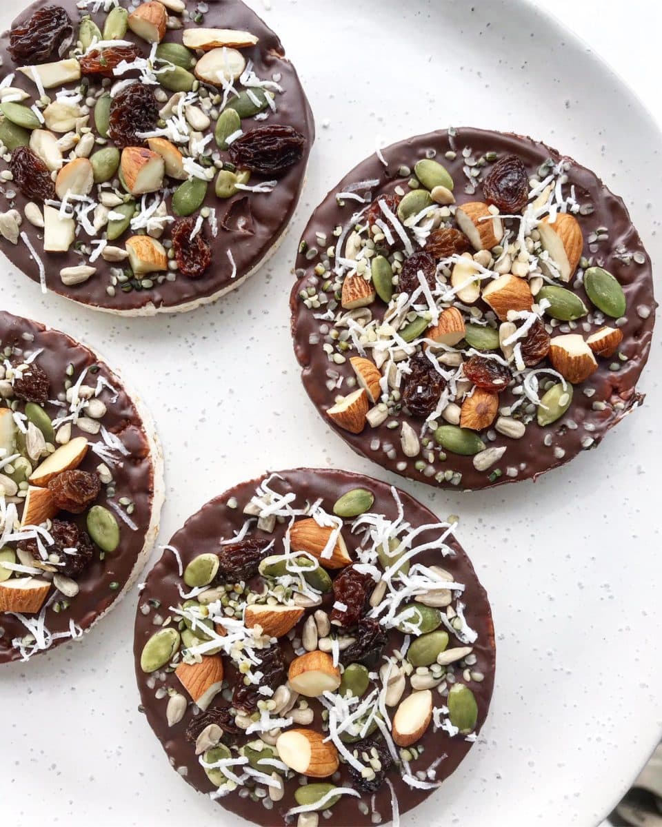 Chocolate-covered rice cakes topped with nuts, seeds and dried fruit. 