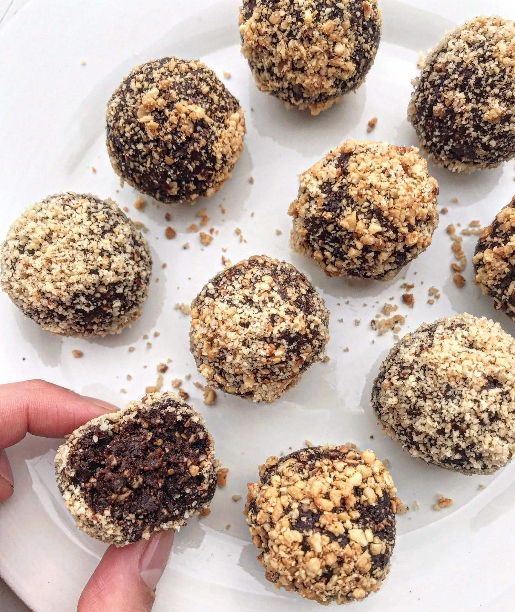 A picture of chocolate hazelnut bliss balls on a white plate.