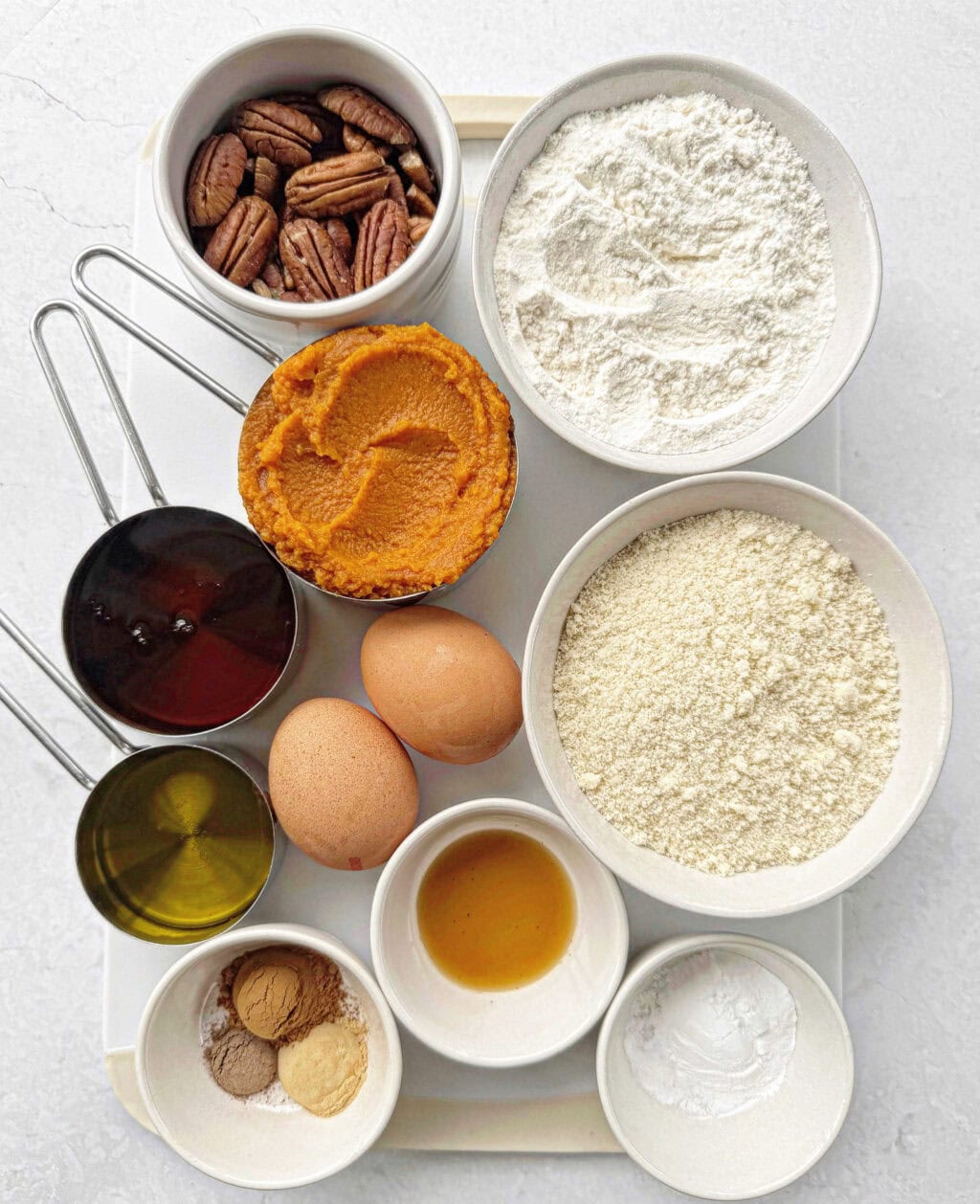The recipe ingredients needed for pumpkin pecan muffins.