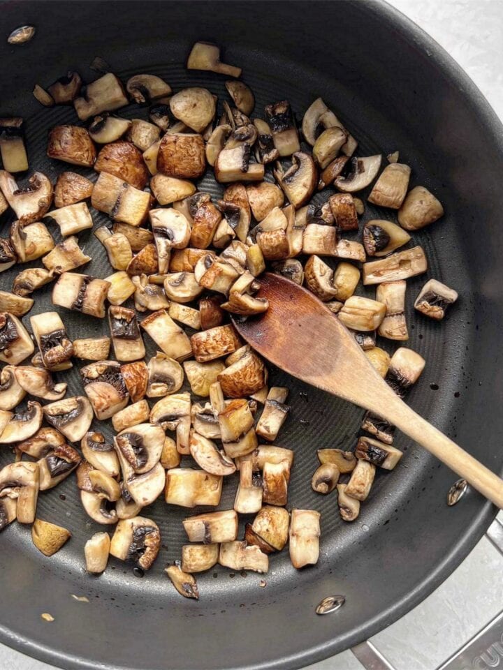 Sautéd mushrooms in a frypan.