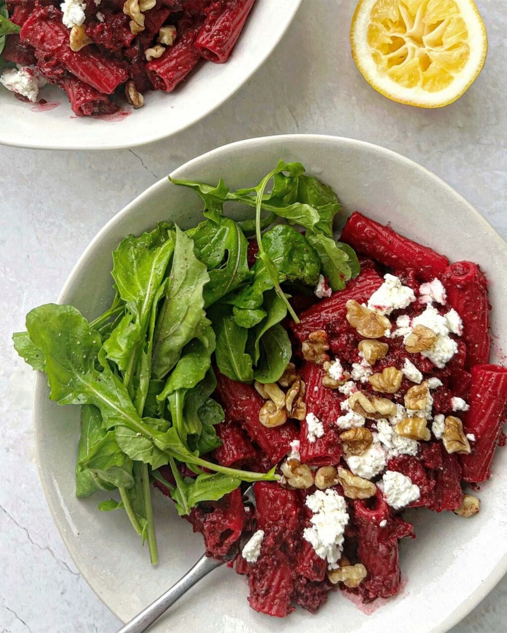 A close up of cooked beetroot goat cheese pasta with lemon rocket. 