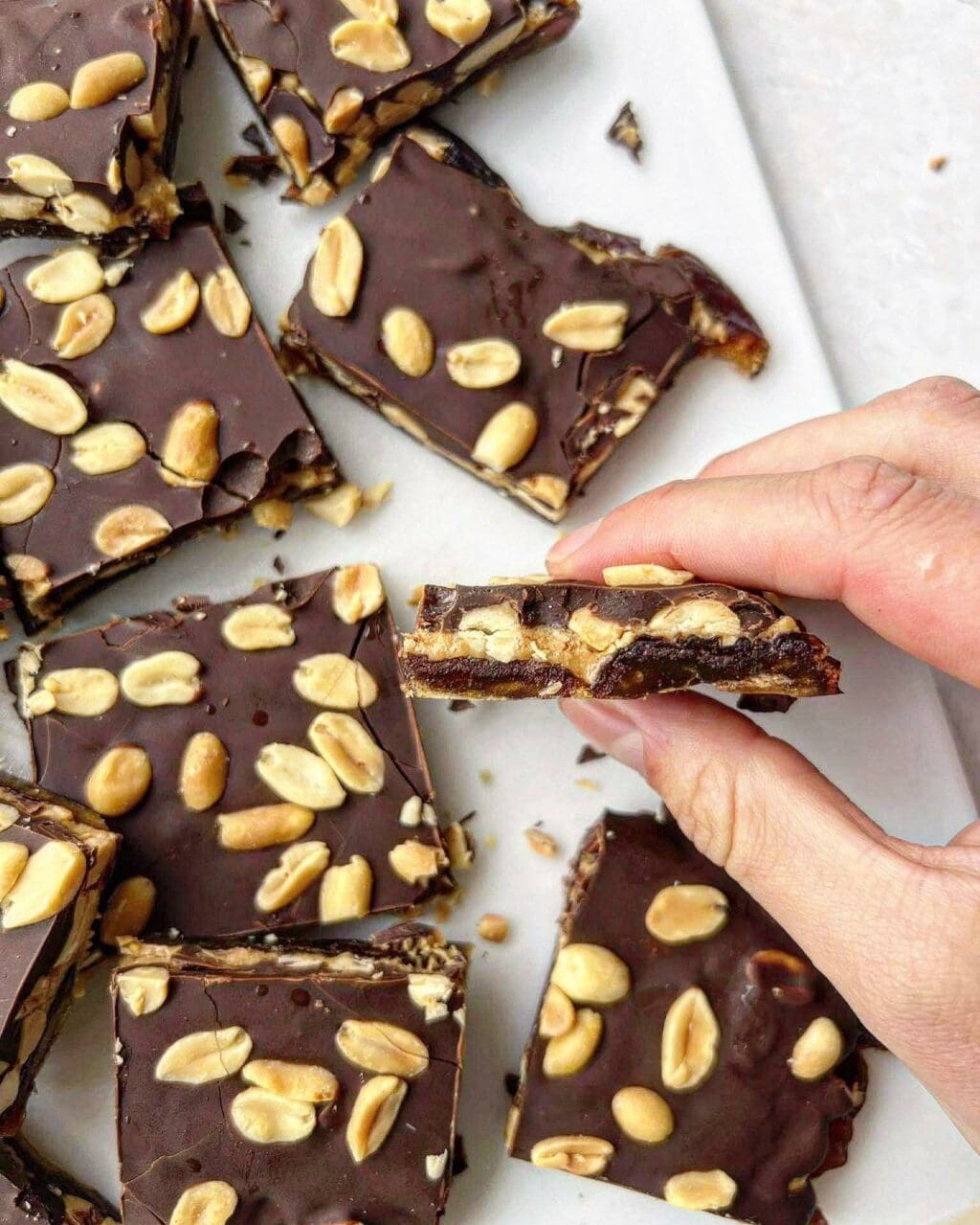 Peanut chocolate date bark sliced into squares